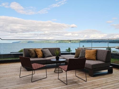 a living room with a couch and chairs on a deck at Quality Hotel Match in Jönköping