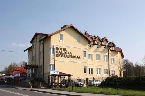 a building with a sign on the side of it at Hotel Galicja SPA Wieliczka in Wieliczka
