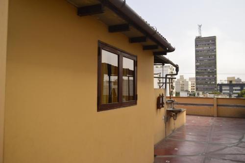 a yellow building with a window on the side of it at Casa Rodas in Lima