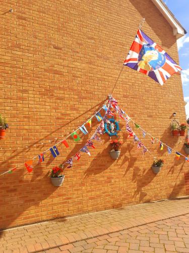 a kite hanging from a brick wall with flags at Marina & Seagulls in East Cowes