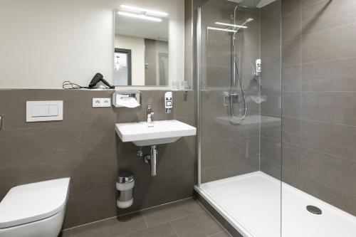 a bathroom with a shower and a sink and a toilet at Himmelreich Braunfels in Braunfels