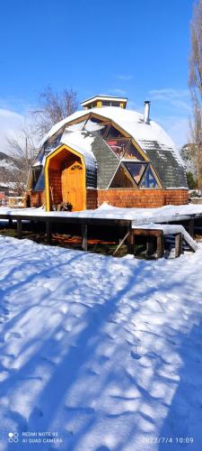 a domed building in the snow with snow at Cabaña y Domo Rinconada de Malalcahuello in Malalcahuello