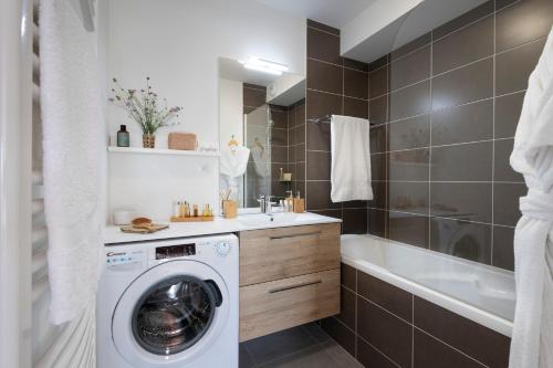 a bathroom with a washing machine and a bath tub at Pierre & Vacances Premium Les Villas d'Olonne in Les Sables-d'Olonne