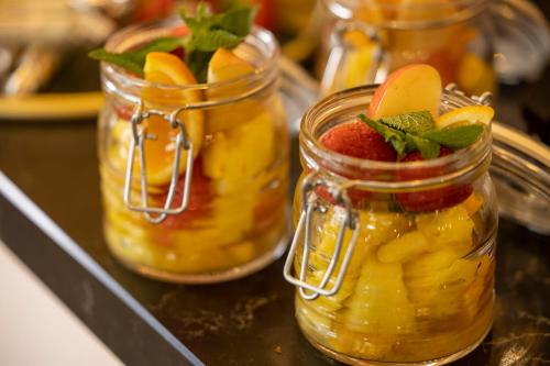 two mason jars filled with fruit on a counter at Hotel Le Rocroy in Paris