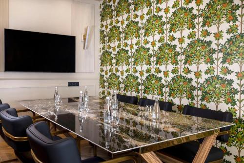 a conference room with a long table and chairs at Hotel Le Rocroy in Paris