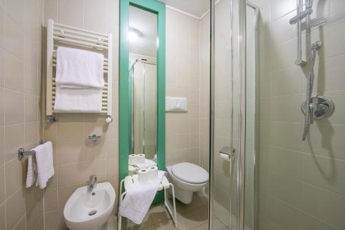 a bathroom with a shower and a toilet and a sink at Villaggio Olimpico in Sestriere
