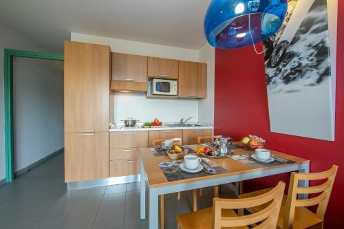a kitchen with a wooden table and a blue balloon at Villaggio Olimpico in Sestriere