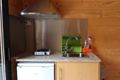 a kitchen counter with a sink and a sink at Outeiro do Moinho in Campo do Gerês