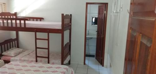 a room with two bunk beds and a mirror at Casa na Praia de Ponta de Pedras in Alter do Chao