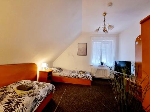 a bedroom with two beds and a window at PRIMEX tani nocleg in Poznań