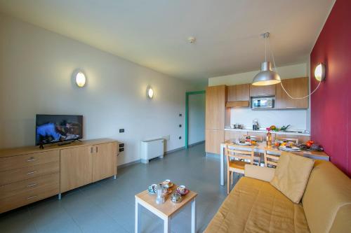 a living room and kitchen with a couch and a table at Villaggio Olimpico in Sestriere