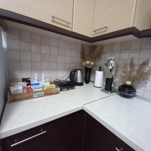 a kitchen counter top with a white counter top at PUZZLE SWEET HOME in Serres