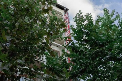 two trees are in front of a building at HOTEL LYBETEN in Ferizaj