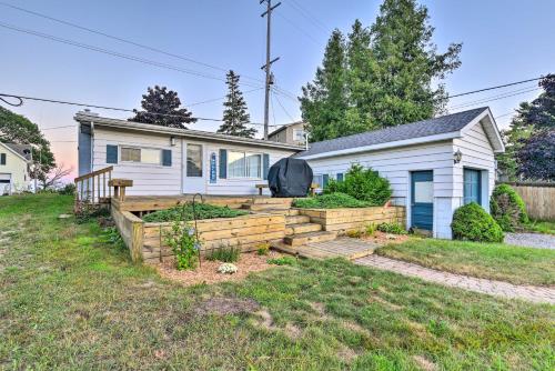 a house with a garden in front of it at East Tawas Cabin with Lake Huron Access and Views in East Tawas