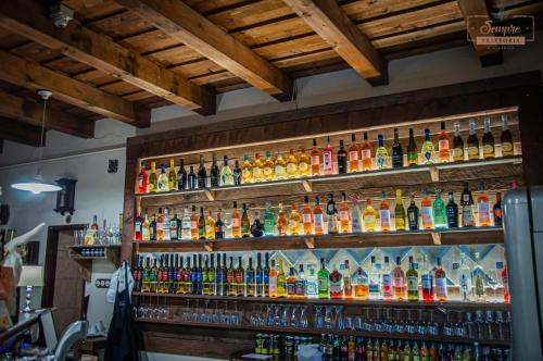 a bar with many bottles of alcohol on the wall at Sempre Étterem És Panzió in Székesfehérvár