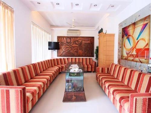 a living room with a couch and a table at Sitara Paradise in Hyderabad
