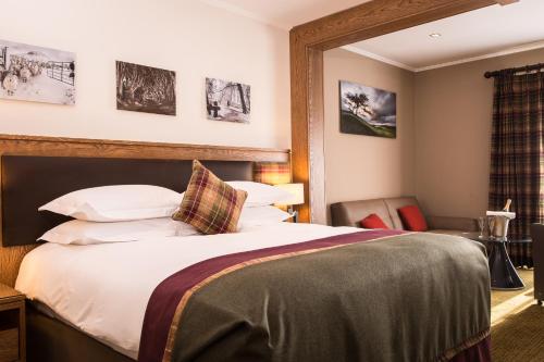 a hotel room with a large bed with white pillows at Galgorm in Ballymena
