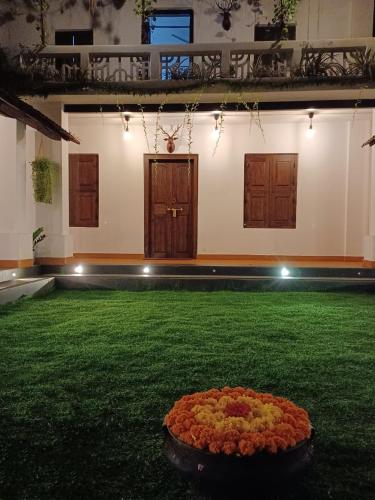 a large room with a large arrangement of flowers on the grass at Kayyalas Courtyard in Trichūr