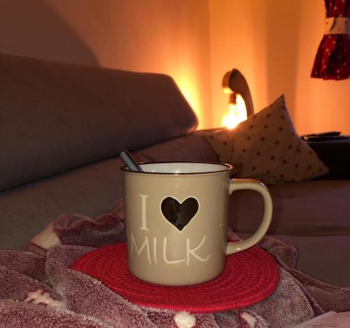 a cup with a heart on it sitting on a blanket at Baita Alpenrose in Ugovizza