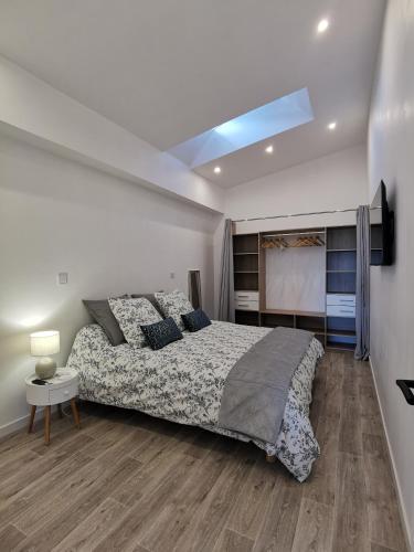 une chambre avec un grand lit et une télévision dans l'établissement Loft 90m2 - Tout confort, à Libourne
