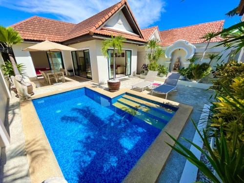 a swimming pool in front of a house at View Talay Villas, luxury private pool villa, 500m from Jomtien beach - 37 in Jomtien Beach