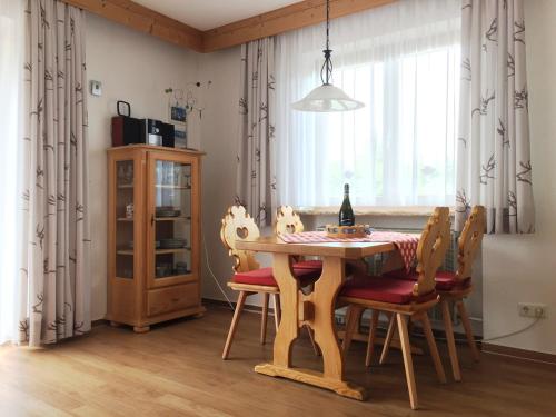 a dining room with a table and chairs and a window at Alpenflair Ferienwohnung 228 Söllereck in Oberstdorf