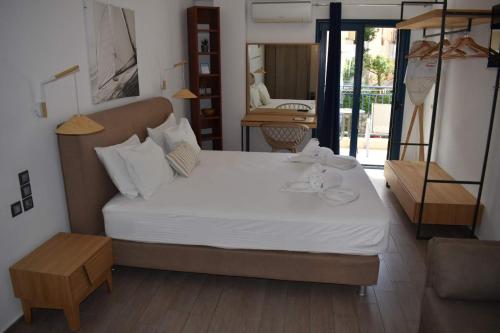 a bedroom with a large white bed in a room at Christina Studios & Apartments in Parga