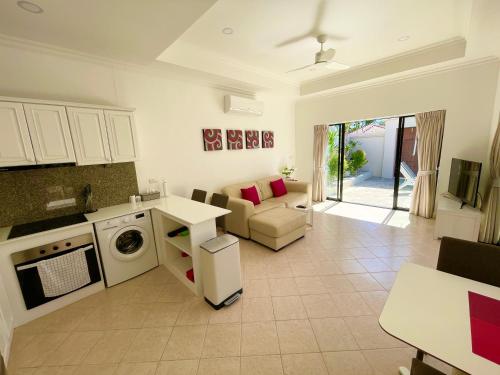 a kitchen and living room with a couch and a dishwasher at View Talay Villas, luxury private pool villa, 500m from Jomtien beach - 37 in Jomtien Beach