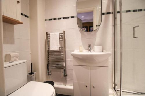 a bathroom with a toilet and a sink and a shower at Three Horseshoes Leamside in Houghton le Spring