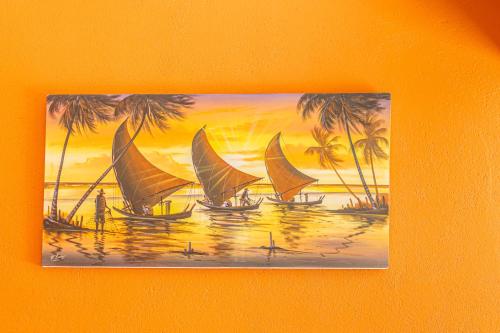 a painting of boats on the water with palm trees at Hotel Preá in Prea