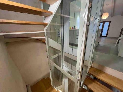 an empty glass cabinet in a room with stairs at NEW! Renovated house with terrace in Cambrils in Cambrils