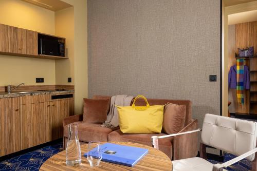 a living room with a couch and a table at Hotel Le Rocroy in Paris