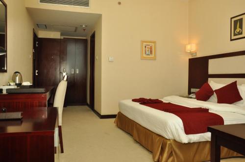 a hotel room with a bed and a desk at Harmony Hotel in Addis Ababa