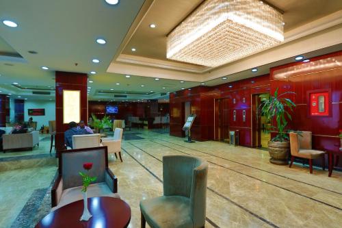 a lobby of a hotel with tables and chairs at Harmony Hotel in Addis Ababa