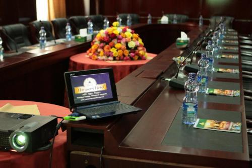 a laptop computer on a long table in a conference room at Harmony Hotel in Addis Ababa