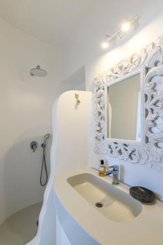 a white bathroom with a sink and a mirror at Villa Isabella Family villa close to the beach in Mikonos