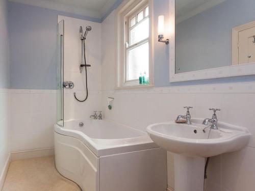 a white bathroom with a sink and a shower at Mount Boone 12a in Dartmouth