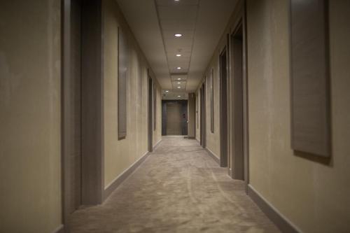 a corridor of a building with a long hallway at Hilly Hotel in Edirne