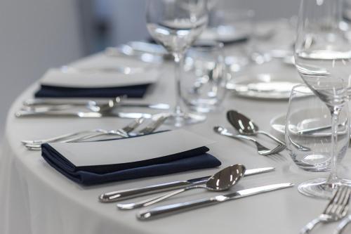 a white table with silverware and forks and spoons at GLAD Yeouido in Seoul