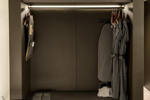 a walk in closet with a door and coats at GLAD Yeouido in Seoul