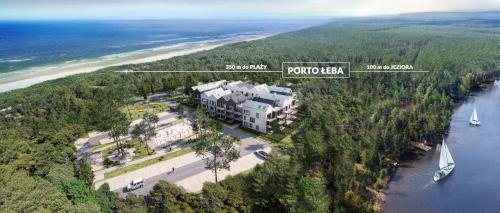 an aerial view of a large building next to the ocean at Apartament Orlando w Porto Łeba 350m od morza in Łeba