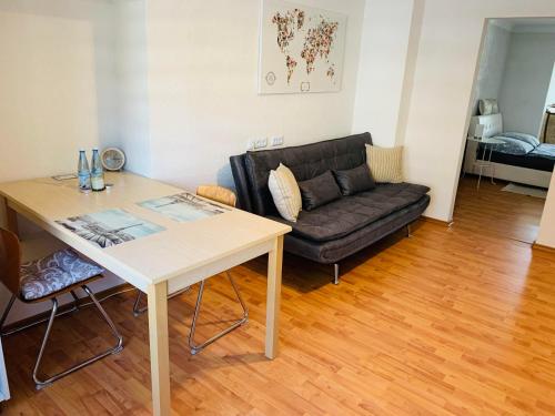 a living room with a table and a couch at Apartment Marielena in Püttlingen
