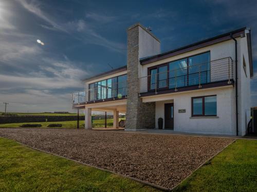 a house with a balcony on the side of it at The Steading in Stromness