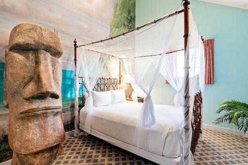 a bedroom with a bed with a large head at Chateau Avalon in Kansas City