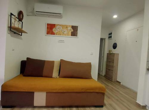 a couch sitting in a living room with at Apartman Zdravkovic & SPA in Veliko Gradište