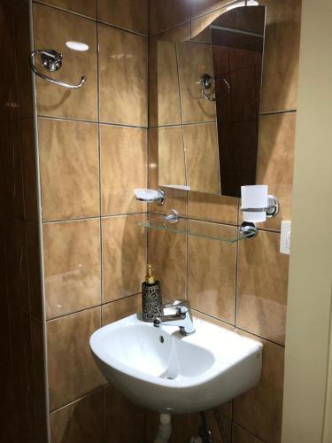 a bathroom with a sink and a mirror at Marmara House&Apartments in Istanbul