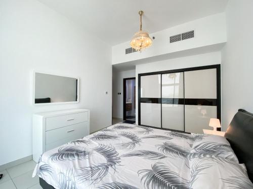 a bedroom with a bed and a flat screen tv at DUBAI - Glitz 3 Residences - MAJESTIC Luxe Holiday Home - 2BR - Sleep 4 - FOR FAMILIES & COUPLES STAYS ONLY in Dubai