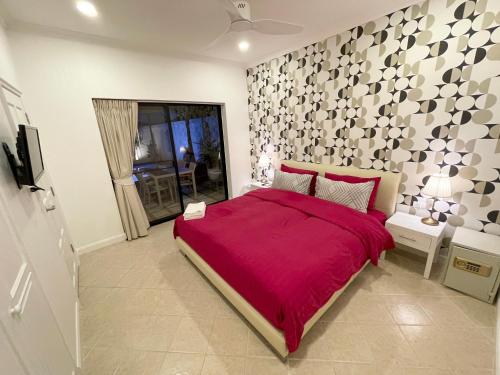 a bedroom with a bed with a red bedspread at View Talay Villas, luxury private pool villa, 500m from Jomtien beach - 37 in Jomtien Beach