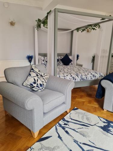 a living room with a couch and a bed at Rainworth Lodge in Nottingham