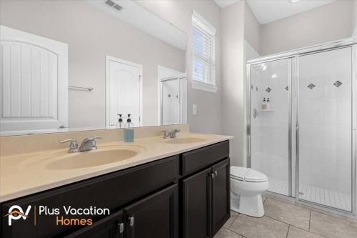 a bathroom with a sink and a shower and a toilet at 4159 -Private Pool&Spa at Resort-slides in Davenport